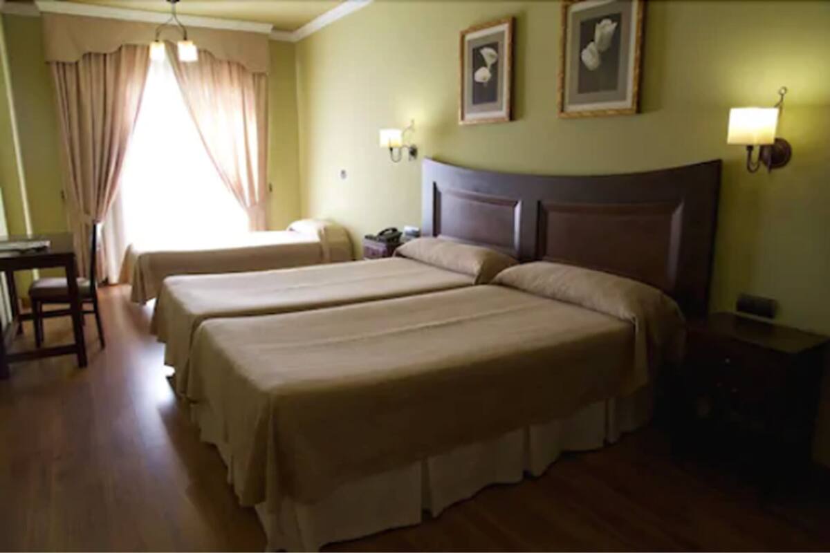 Triple Room, Balcony | Down comforters, in-room safe, desk, blackout drapes