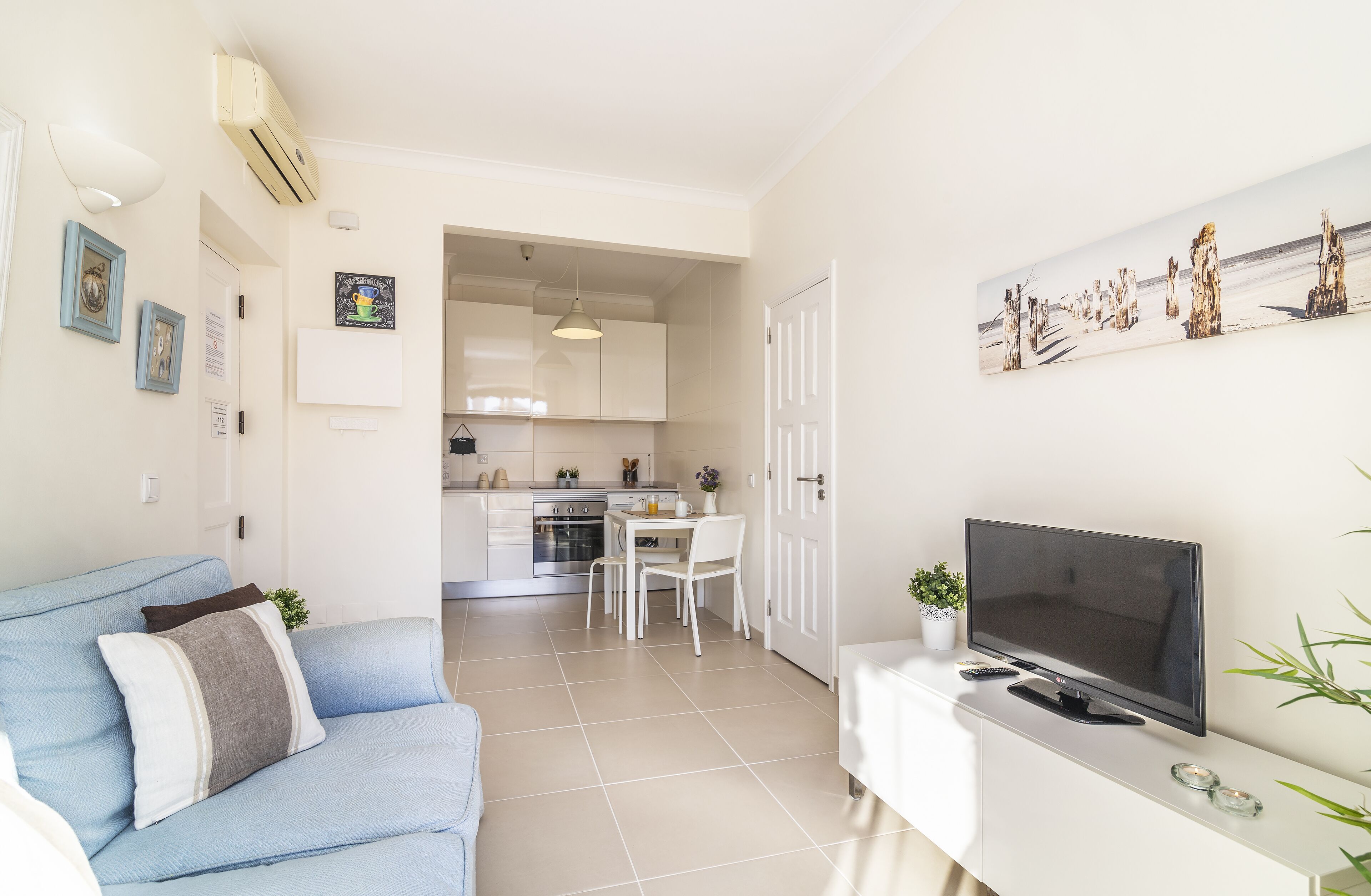 A modern apartment with a living room, kitchen, and dining area.