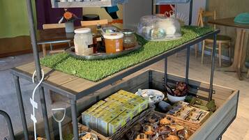 A food cart with various food items and condiments.