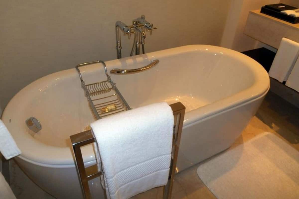 Une salle de bain standard équipée d'une baignoire, d'un porte-serviettes et de toilettes.