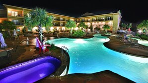 A hotel with a swimming pool, outdoor seating, and a guard standing by the pool. - Holiday Inn Express & Suites Fredericksburg by IHG (Fredericksburg)