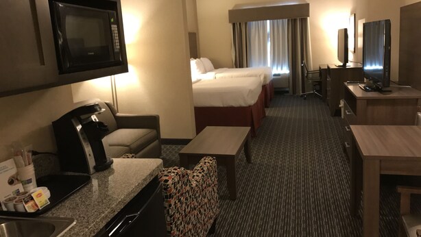 A hotel room with a kitchenette, a bed, a desk, and a TV. - Holiday Inn Express & Suites Fredericksburg by IHG (Fredericksburg)