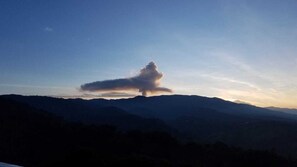 A mountain landscape with a prominent cloud formation. - Hotel Alto Palomo (Toro Amarillo)