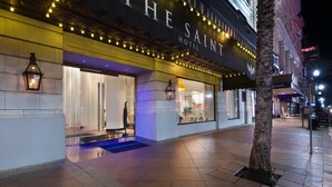 The Saint Hotel with a marquee sign, illuminated entrance, and a visible storefront. - The Saint Hotel, New Orleans, French Quarter (New Orleans)