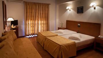 Standard Triple Room, Private Bathroom | Minibar, in-room safe, desk, blackout drapes