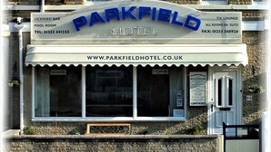 A hotel named Parkfield with a signboard indicating a licensed bar, pool room, and TV lounge. - Parkfield Hotel (Blackpool)