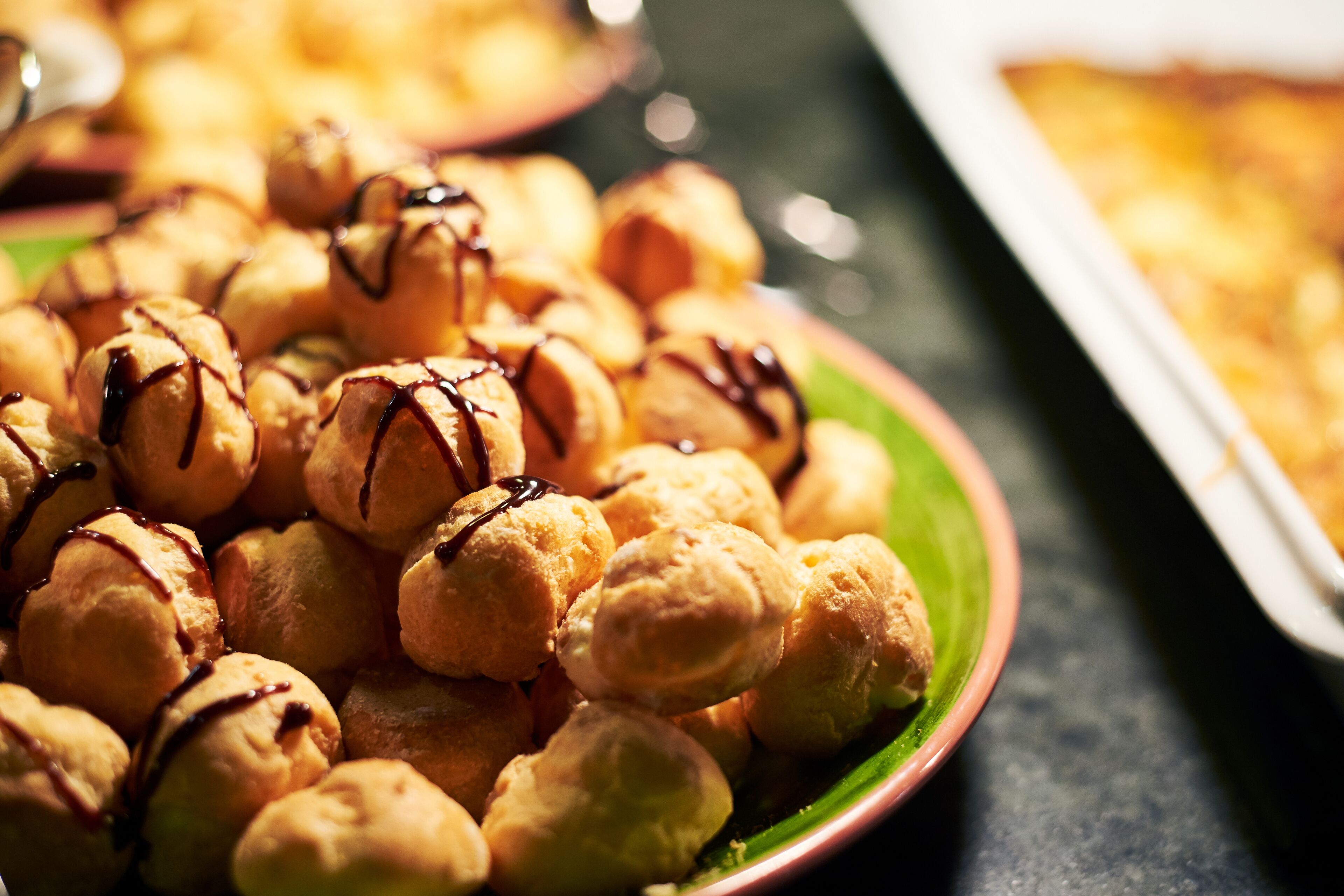 A plate of chocolate-dipped profiteroles.