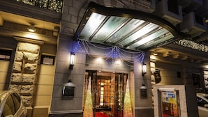 The entrance of the Le Bihon Hotel with a red carpet, stone facade, and decorative lights. - Hotel Blion Naha (Naha)