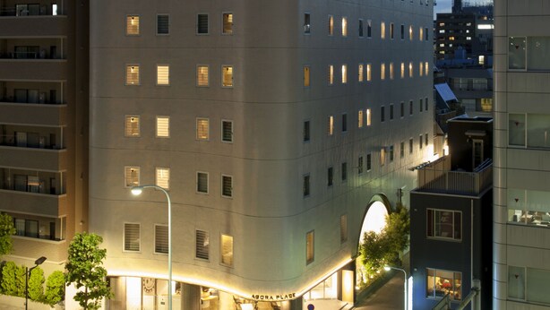 A multi-story hotel with a prominent "ABORA PLACE" sign, featuring a modern architectural design with a flat roof and numerous windows. - Agora Place Tokyo Asakusa (Tokyo)