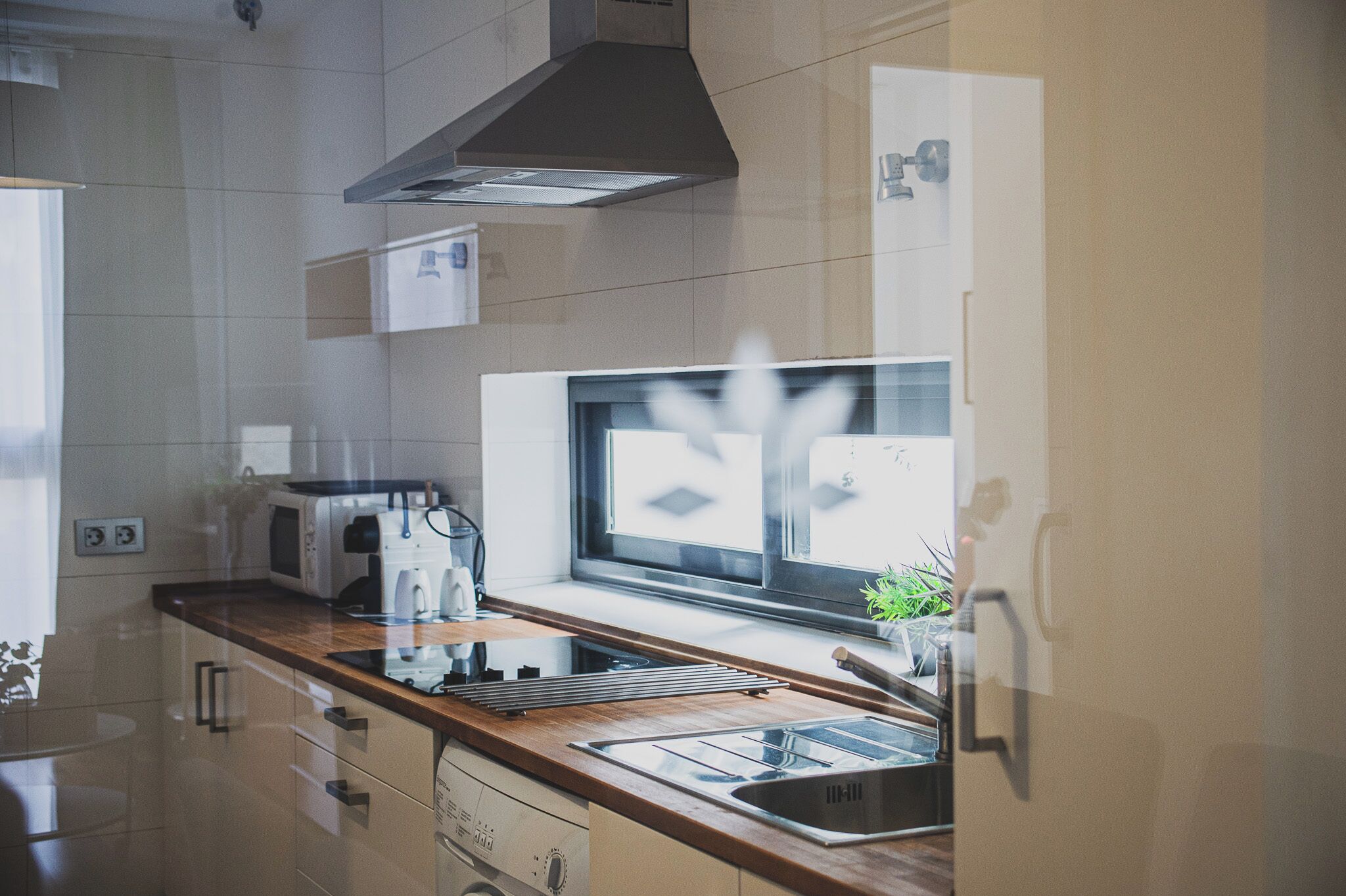 A modern kitchen with a microwave, toaster, and sink.