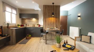 Deluxe Duplex | Living area | 50-cm flat-screen TV with cable channels, TV