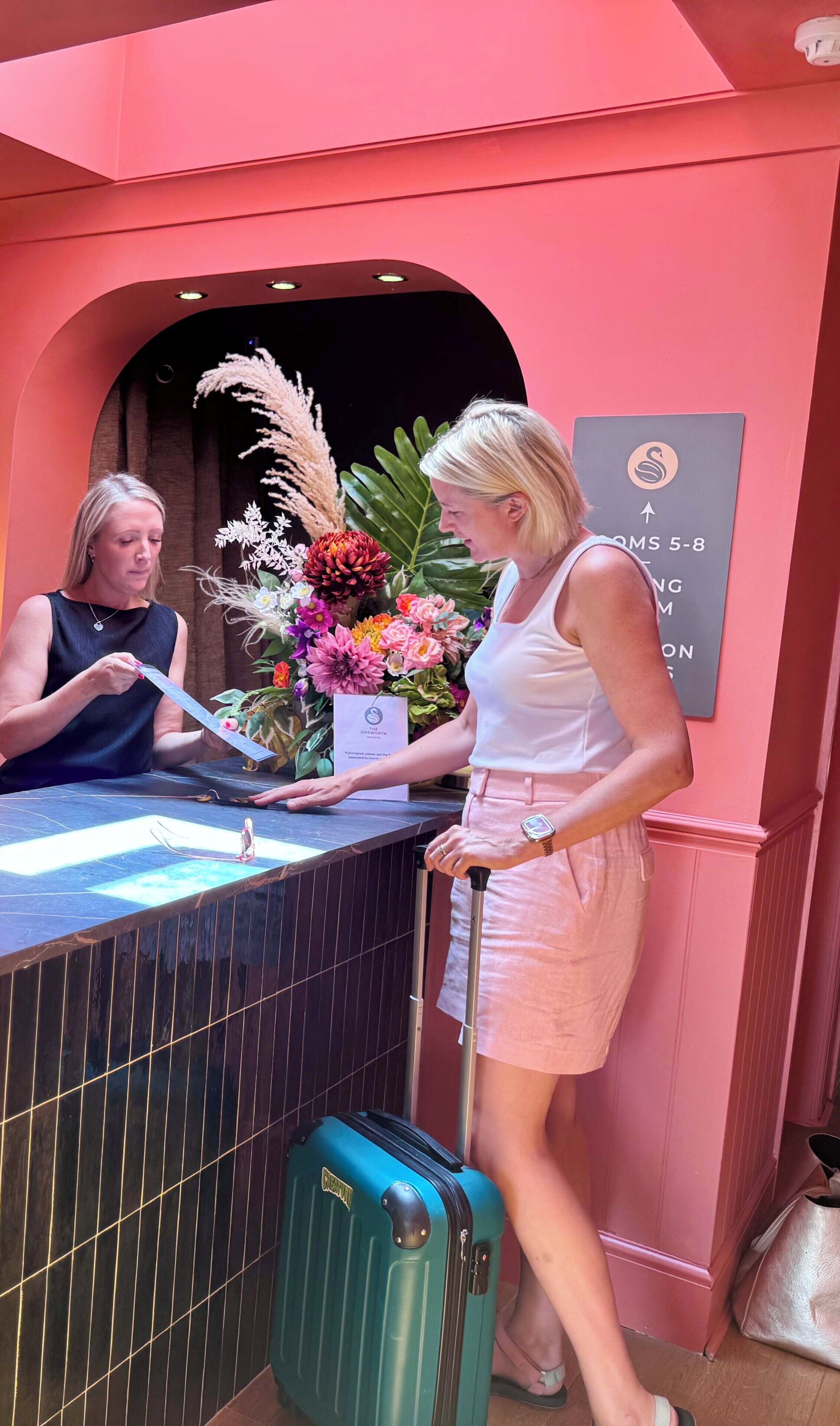 A reception desk with a sign indicating room numbers 5-8.