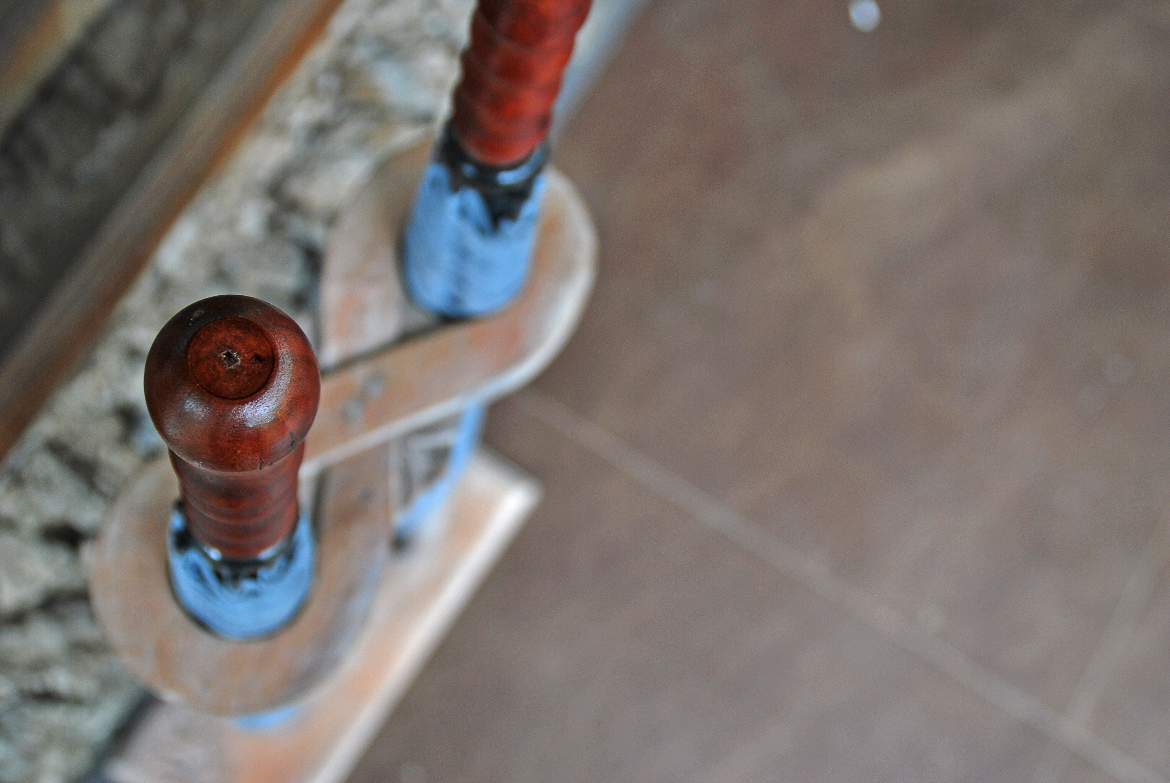 A close-up of wooden handrails with a metal base, likely part of a staircase or platform.