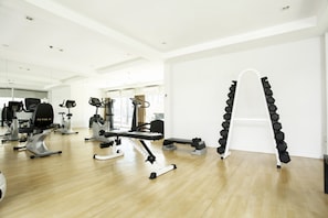 A gym with various exercise equipment, including treadmills and a stair climber.