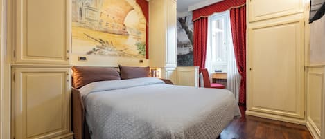 A bedroom with a large bed, a painting on the wall, and a window with red curtains.