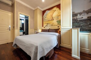 A hotel room with a large bed, a painting of a bridge, and a view of a river.