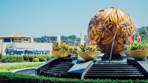 A large decorative water feature with a tiger motif, surrounded by steps and potted plants, with a sign for Azalea Residences in the background. - Azalea Hotels & Residences Baguio (Baguio)