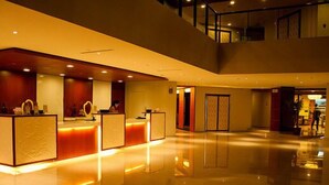 A spacious lobby with a reception desk, a staircase, and a view of the interior. - Azalea Hotels & Residences Baguio (Baguio)