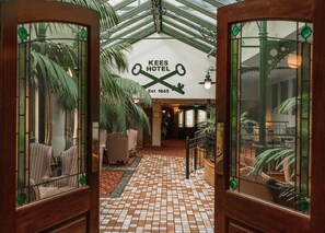 A hotel lobby with a checkered floor, striped chairs, and a sign reading "KEES HOTEL Est 1845". - Kee's Hotel  (Stranorlar)