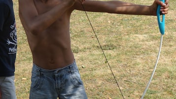 A person holding a bow and arrow outdoors.