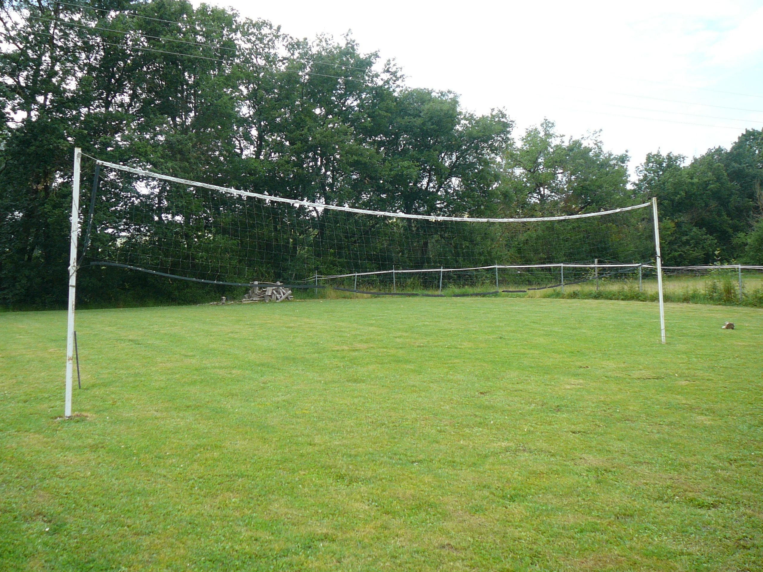A grassy field with a soccer goal and net.