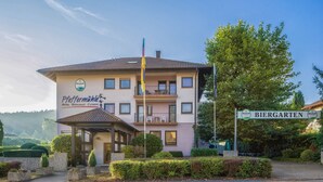 A hotel with a sign reading "Pfeffermühle Hotel, Restaurant, Catering" and a nearby sign for "Biergarten." - HRC Pfeffermühle (Landstuhl)