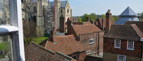 A view of a historic town with traditional buildings and a prominent church with a tall spire.