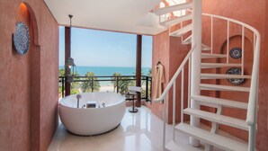 A modern bathroom with a large bathtub, a view of the sea, and a spiral staircase. - Marrakesh Hua Hin Resort & Spa (Hua Hin)
