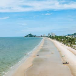 On the beach, white sand, beach umbrellas, beach towels
