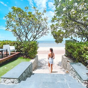 On the beach, white sand, beach umbrellas, beach towels