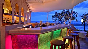 A bar area with a view of the ocean, featuring a tiled backsplash and stools. - Marrakesh Hua Hin Resort & Spa (Hua Hin)