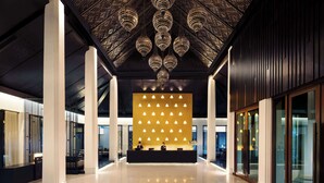 A modern hotel lobby with a reception desk, large columns, and a patterned ceiling. - Avani Khon Kaen Hotel & Convention Centre (Khon Kaen)