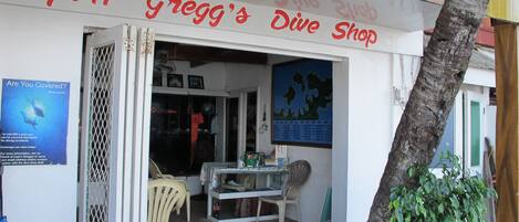 A dive shop named 'Capt'n Gregg's Dive Shop' with a sign above the entrance.
