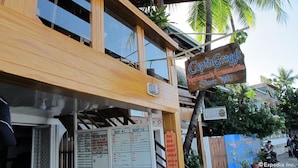 A wooden building with a sign reading "CaptinGregg's Restaurant, Accommodation Since 1983". - Capt'n Gregg's (Puerto Galera)