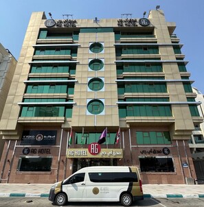 A multi-story hotel with a modern architectural design, featuring a prominent 'AG HOTEL' sign at the entrance. - AG Hotel (Abu Dhabi)
