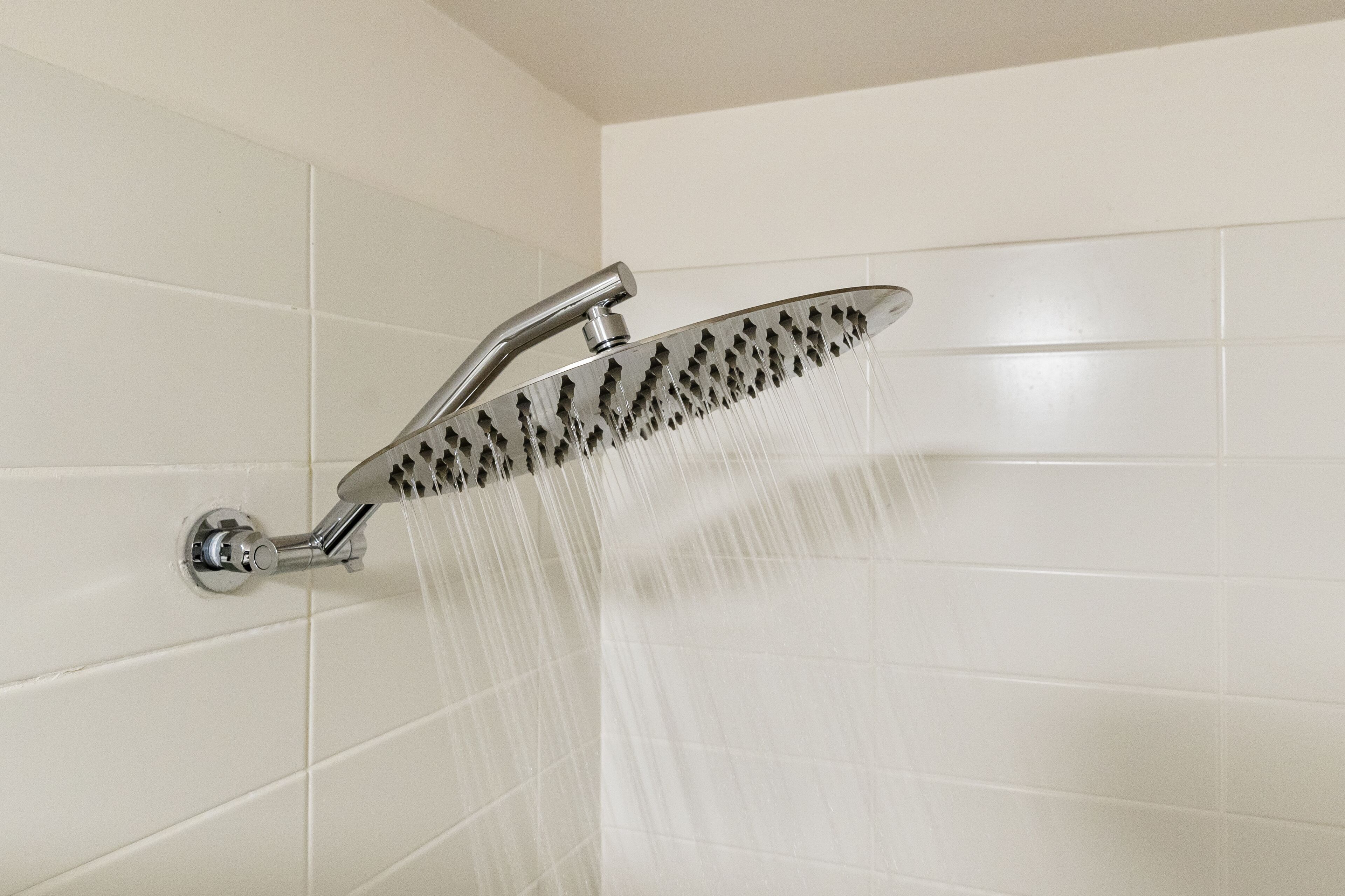 A showerhead with water flowing from it.