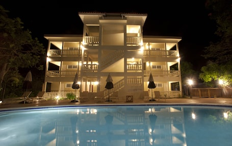 Outdoor pool, pool umbrellas, sun loungers. Sandy Haven Resort