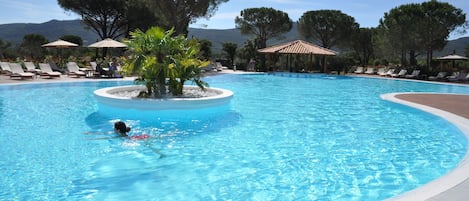 Seasonal outdoor pool, open 9:00 AM to 7:00 PM, pool umbrellas