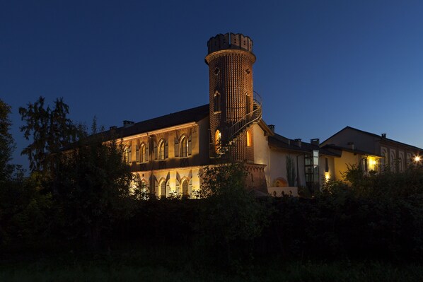 A historic building with a prominent tower and arched windows.