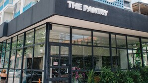 A building with a large sign reading "Bioo The Pantry" and a glass storefront. - Bloo Bali Hotel (Legian)