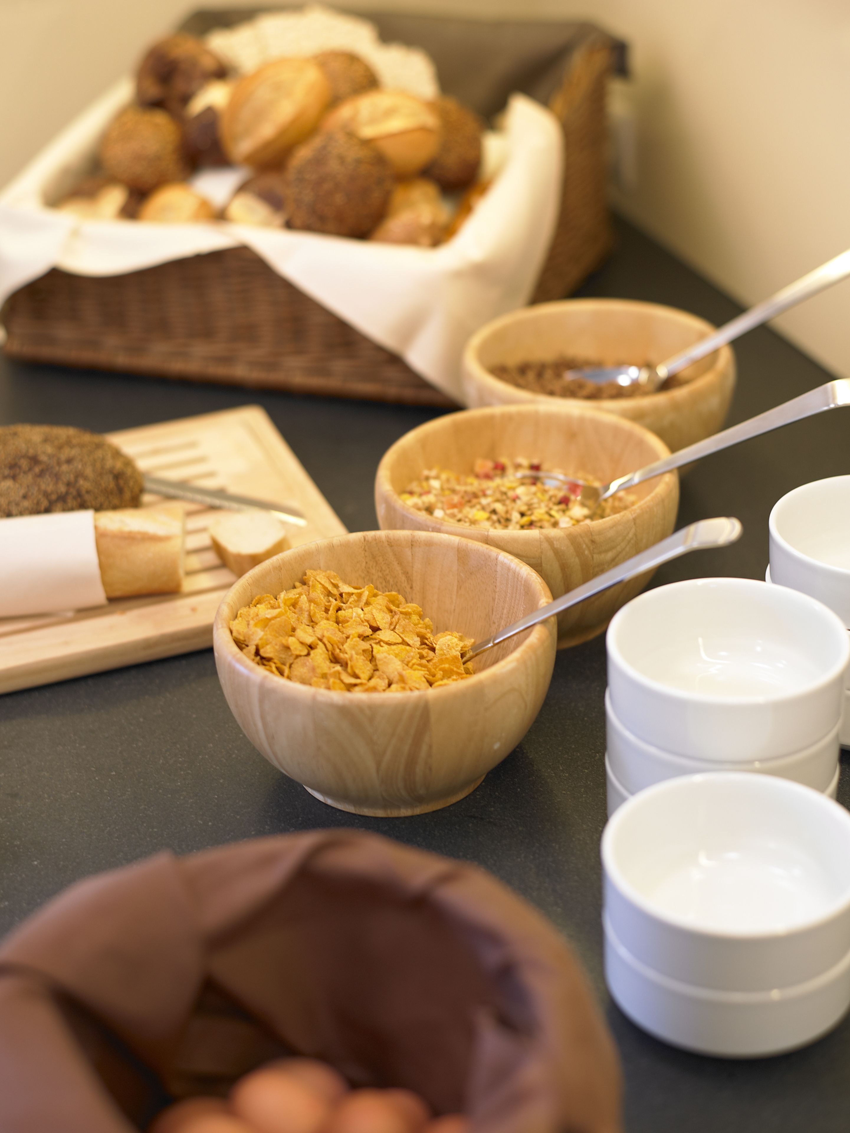A breakfast buffet with various food items and utensils.