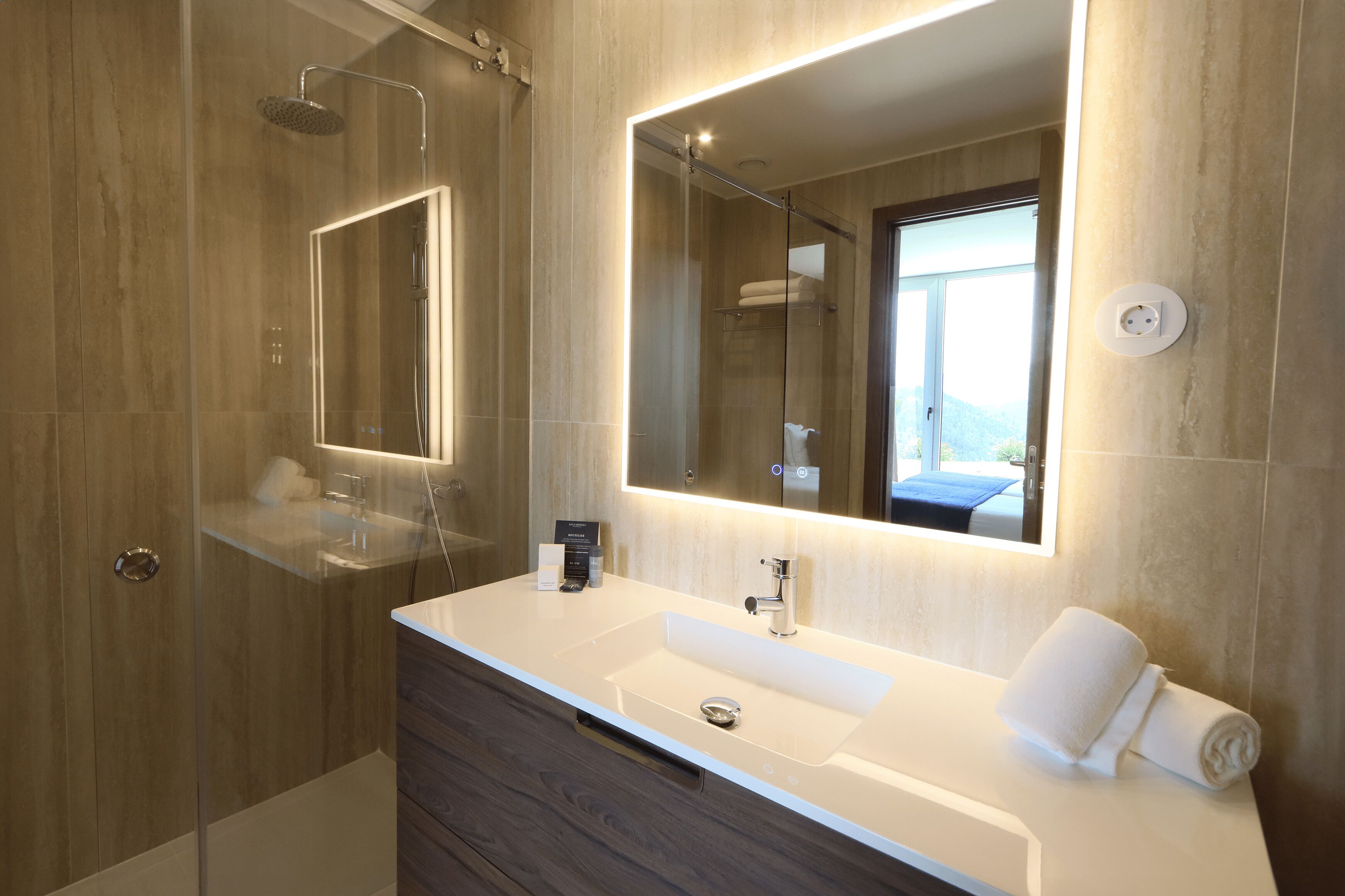 designer toiletries, hair dryer, bidet, towels