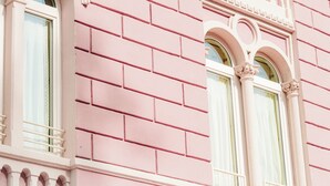 A pink building facade with the word "BELLEVUE" visible. - Bellavista Lakefront (Riva del Garda)