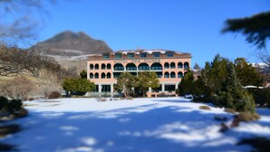 A hotel with a classic architectural style, featuring multiple arches and a prominent sign.