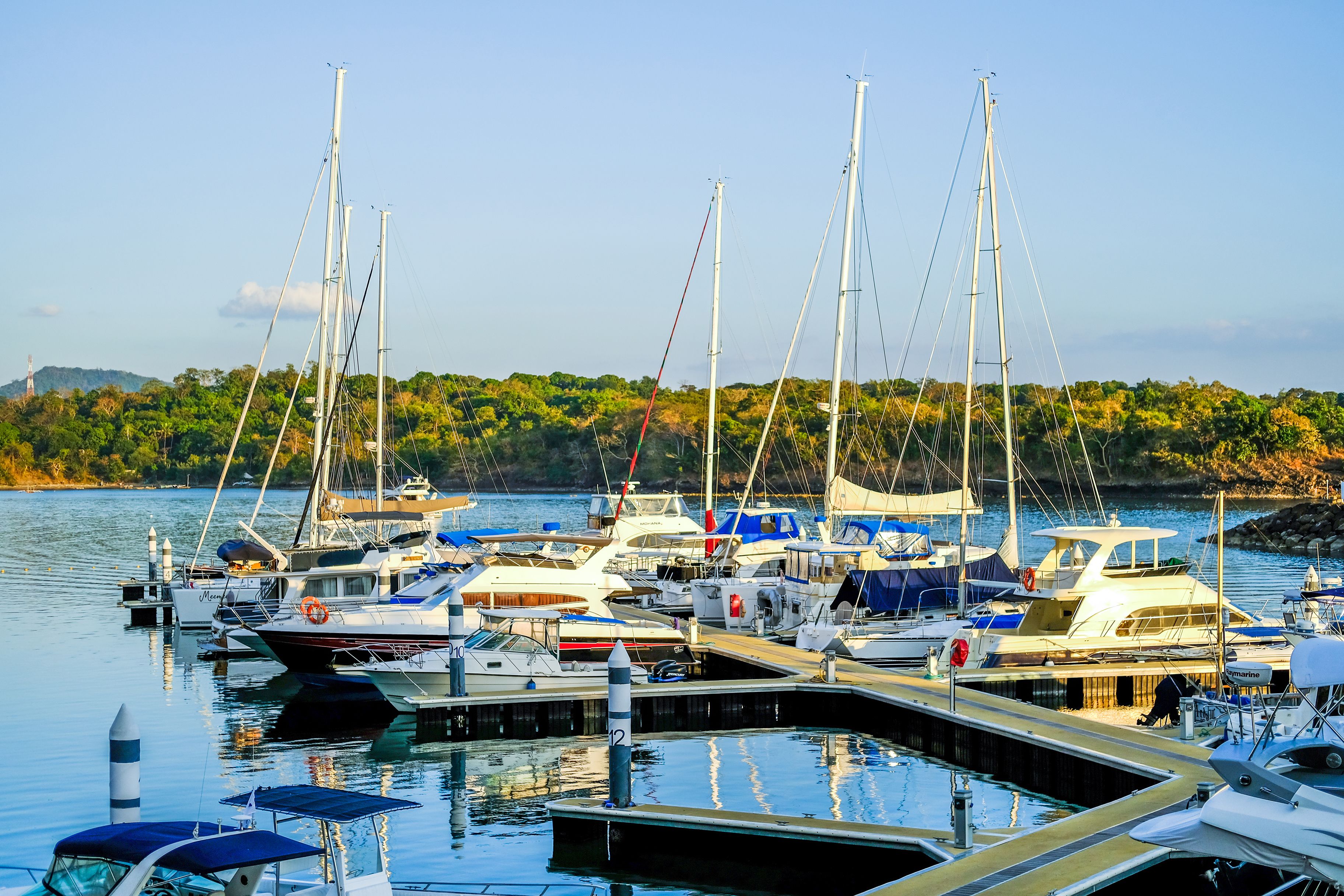 A marina with various boats docked at the pier.