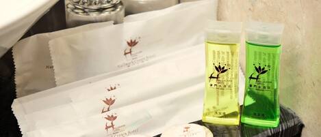 Toiletries including shampoo and soap on a shelf.