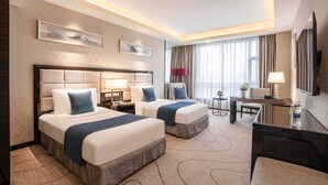 A hotel room with two beds, a desk, a chair, a TV, and a large window with curtains. - Zhengfangyuan International Hotel (Zhengzhou)