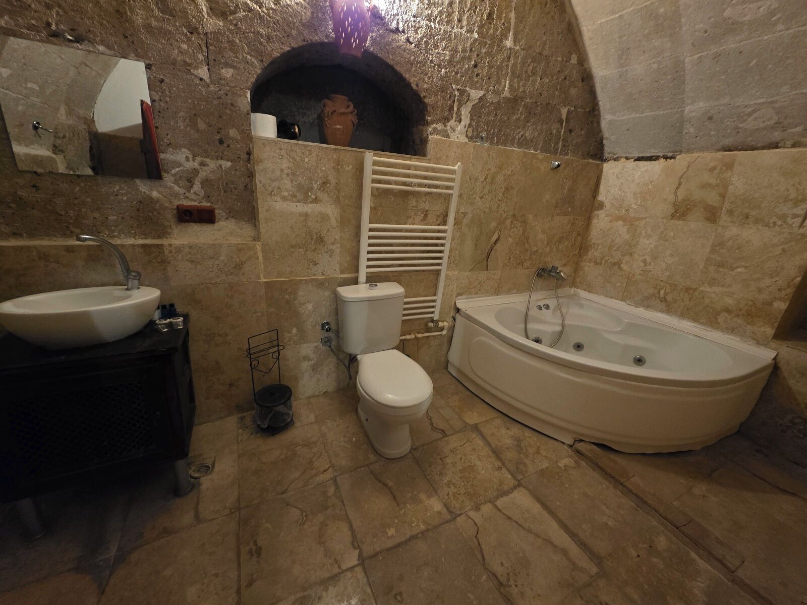 A bathroom with a bathtub, toilet, and sink.