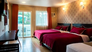 A hotel room with two beds, a desk, and a view of the outdoors. - Tagaytay Wingate Manor (Tagaytay)