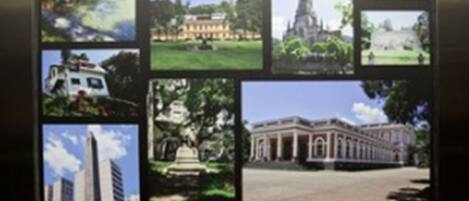 A display of various architectural styles and landmarks, including a large building with columns, a modern skyscraper, and a traditional house with a garden.